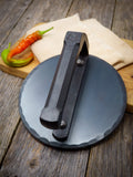 hand forged carbon steel smash burger press behind