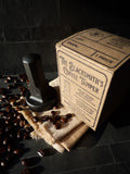 alternate view of hand forged coffee tamper and packaging showing the hand printed inscriptions on both top and site of box