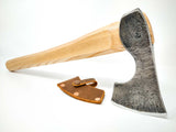 Perspective view of camp hatchet showing forged texture, makers mark and leather sheath
